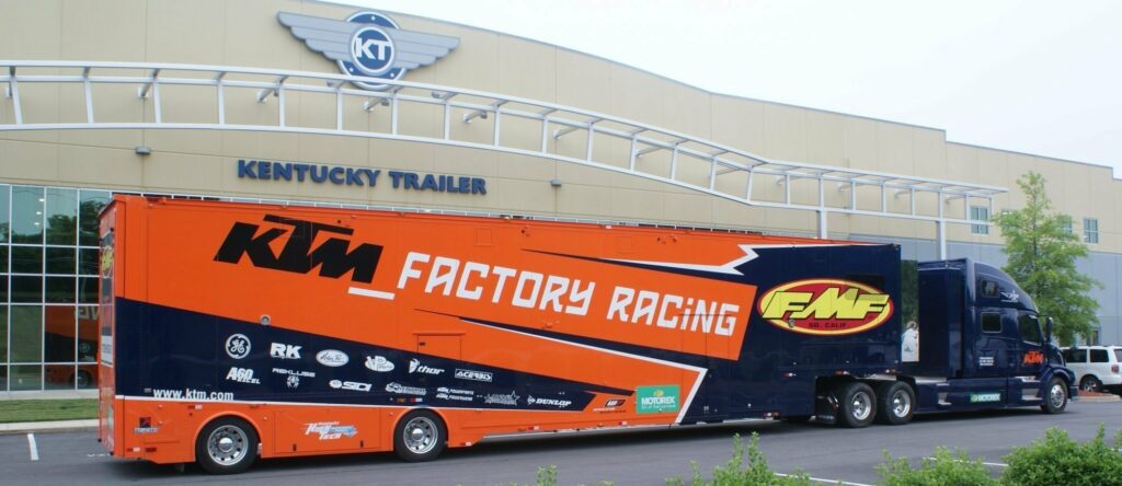 large orange trailer that says factory racing