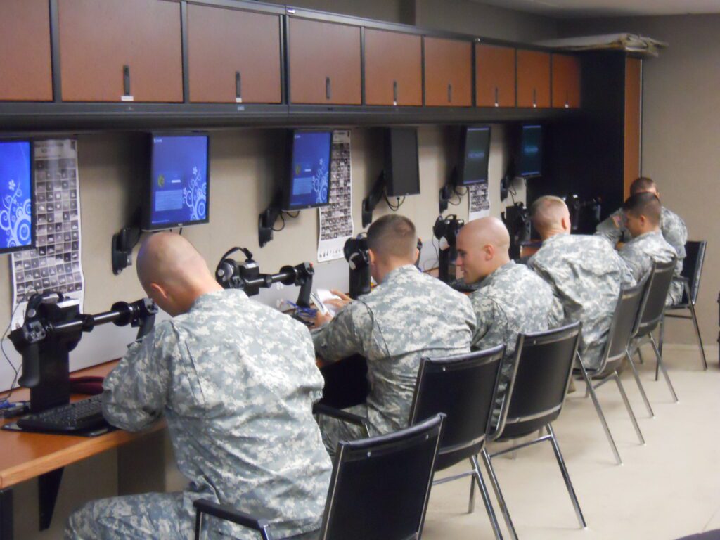 soldiers studying inside of a trailer