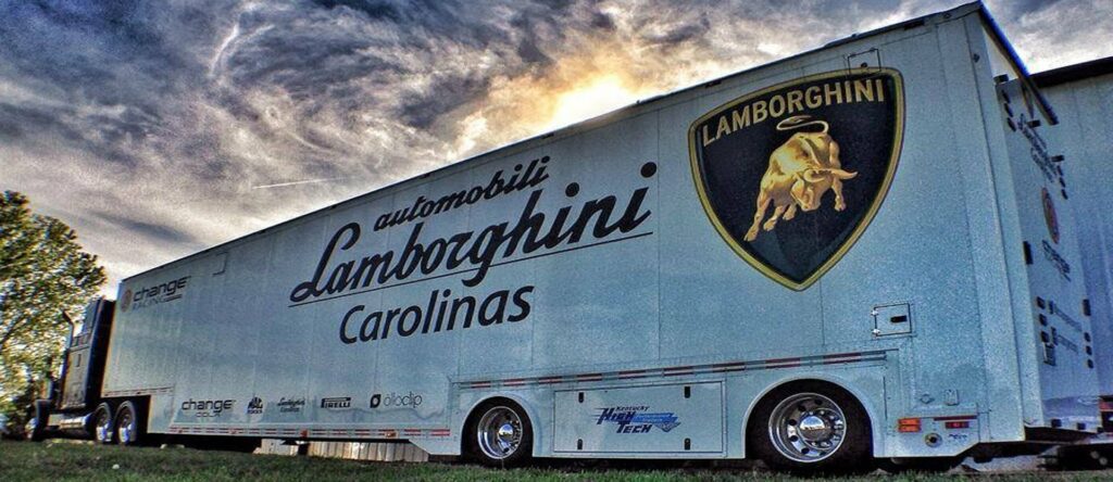 a white autoracing trailer with a Lamborghini logo