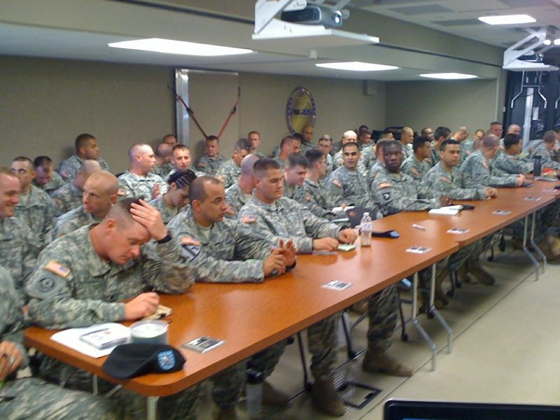 roughly 30 students in camo inside of the trailer