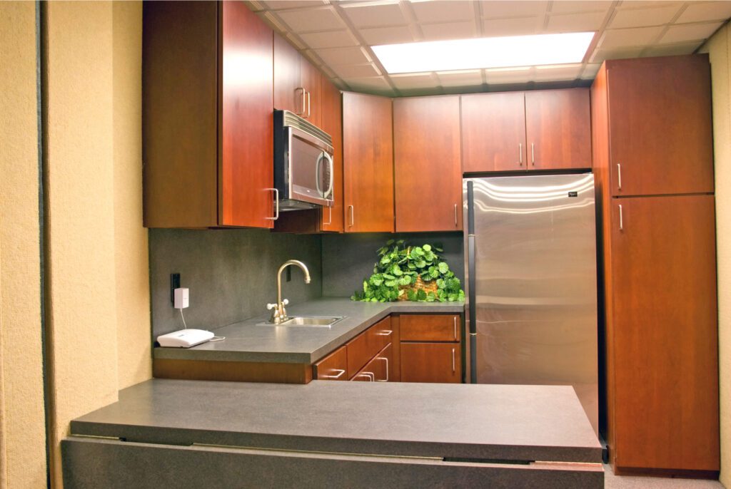 kitchen with fridge and counters and brown cabinets