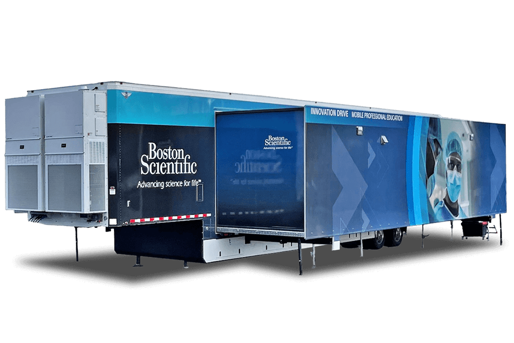 Two blue and white trailers with "Boston Scientific" logos are parked side by side on a paved surface.