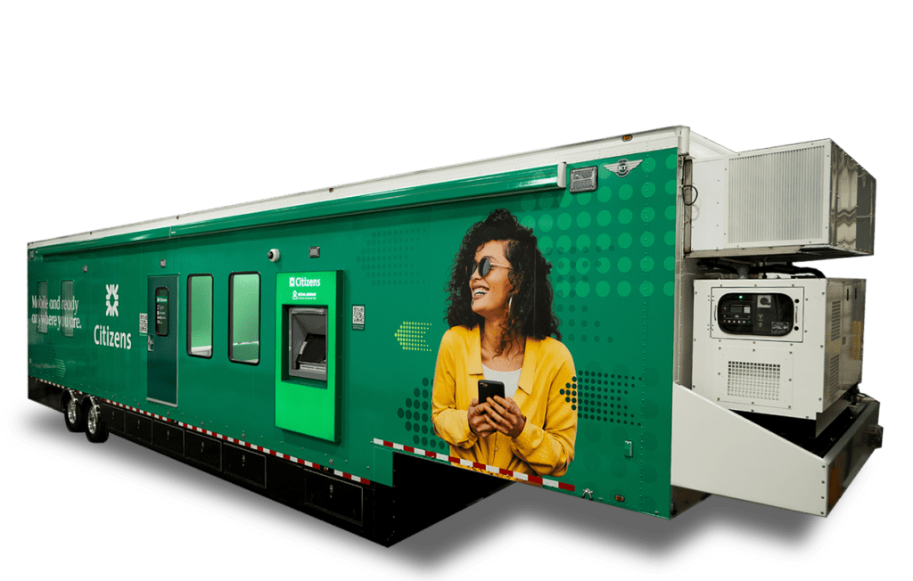 A woman wearing sunglasses and a yellow jacket is standing in front of a green vending machine.