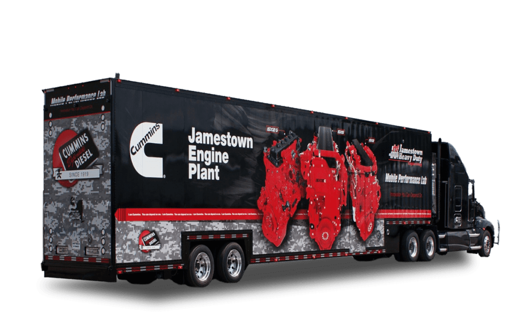 A large black trailer with red engine component graphics and the text "Jamestown Engine Plant" prominently displayed on its side.