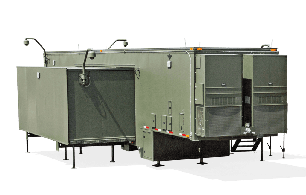 A green mobile trailer with an extended canopy and fold-out steps appears designed for outdoor use or field operations.