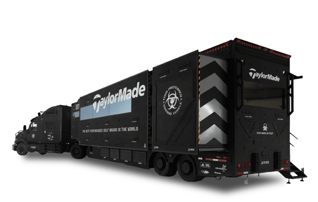 A black TaylorMade-branded trailer with a trailer attached, featuring chevron markings and a logo on the side.