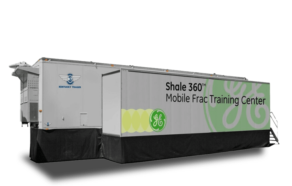 A large white trailer with green and gray accents features the text "Shale 360° Mobile Frac Training" and a logo on its side.